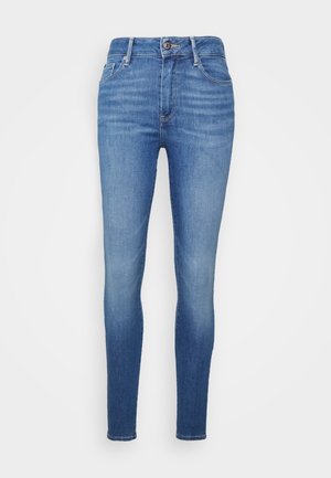 Blauwe skinny jeans met hoge taille, vooraan knoop- en ritssluiting, voor- en achterzakken en subtiele vervaagde details.