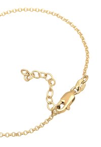 Bracelet en or avec des maillons ronds, un fermoir modèle homard et une longueur ajustable avec plusieurs points de connexion.