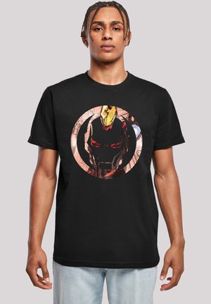 Black cotton T-shirt featuring a graphic design of a superhero in a circular frame with red, gold, and black colors. Short sleeves.