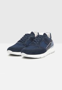 Sneakers blu navy con una combinazione di materiali in suede e rete, caratterizzati da una suola bianca, lacci rotondi e dettagli in pannello di un colore contrastante.