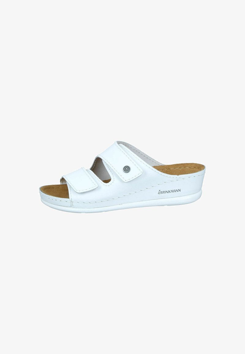 White slide sandal with two adjustable hook-and-loop straps, cork insole, and rubber outsole. Features a rounded toe and slight heel.