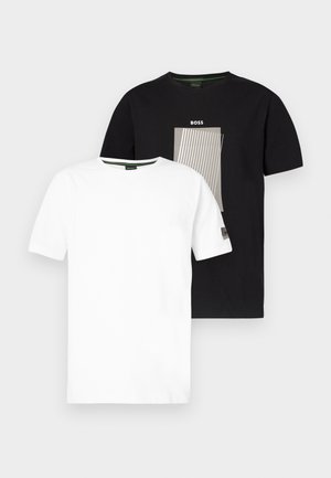 Two short sleeve T-shirts: one white, one black with a graphic design in gray and white. Both have a crew neckline and are made from cotton.