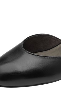 Chaussure à enfiler en cuir noir brillant avec bout rond et doublure intérieure douce, présentée en gros plan sur fond blanc.