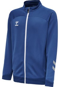 Blå lynlåsjakke lavet af struktureret stof, med høj krave, hvid lynlås og sølv diagonale striber på ærmerne. Logo på brystet.