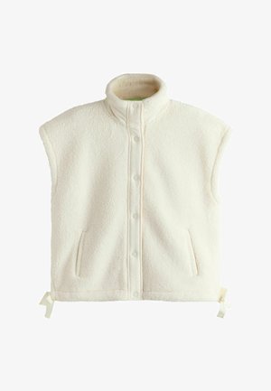 Bezrękawnik z kremowego polaru z kołnierzem typu stójka, zapięciem na zatrzaski, kieszeniami bocznymi oraz regulowanymi sznurkami u dołu.