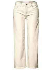 Jean large couleur crème clair en denim, avec poches avant, fermeture par bouton et texture lisse.