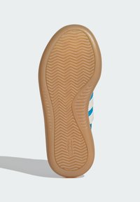 Blue sneaker sole with a herringbone pattern, rubber material, and a contrasting tan outsole. Features three white stripes on the side.