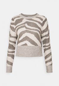 Sweter o kroju cropped w wzór zebry, wykonany z teksturowanej tkaniny w odcieniach beżu i brązu, z długimi rękawami oraz prążkowanym dekoltem i dolnym brzegiem.