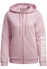 Sweat à capuche zippé Adidas rose clair avec capuche réglable par cordon, poches latérales, poignets et ourlet côtelés, et logo Adidas blanc sur la poitrine et la manche.