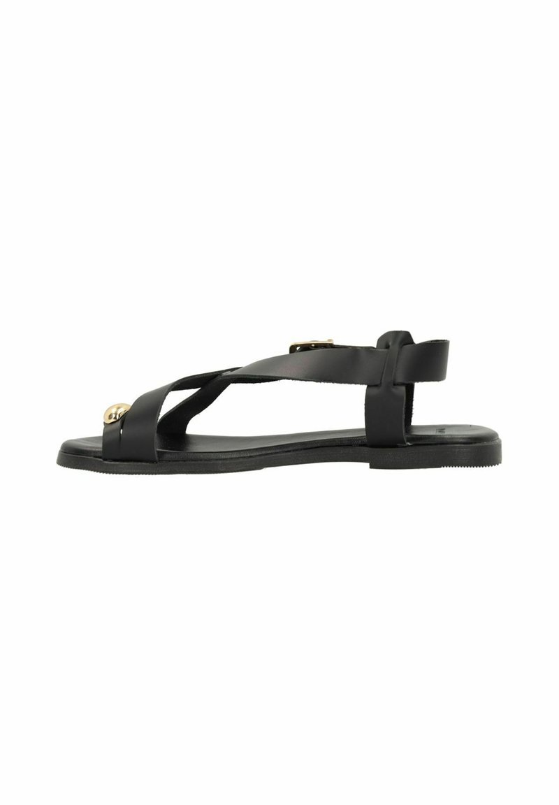 Black sandal with crisscross strap design, flat sole, smooth texture, adjustable back strap, and gold accents on front.