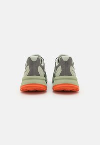 Gray and green athletic shoes with mesh uppers, contrasting orange soles, and subtle branding on the side, viewed from the back.