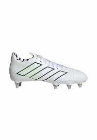 Botín de fútbol blanco con acentos en azul marino y costuras verdes, con una superficie texturizada, parte delantera con cordones y tacos moldeados para tracción.