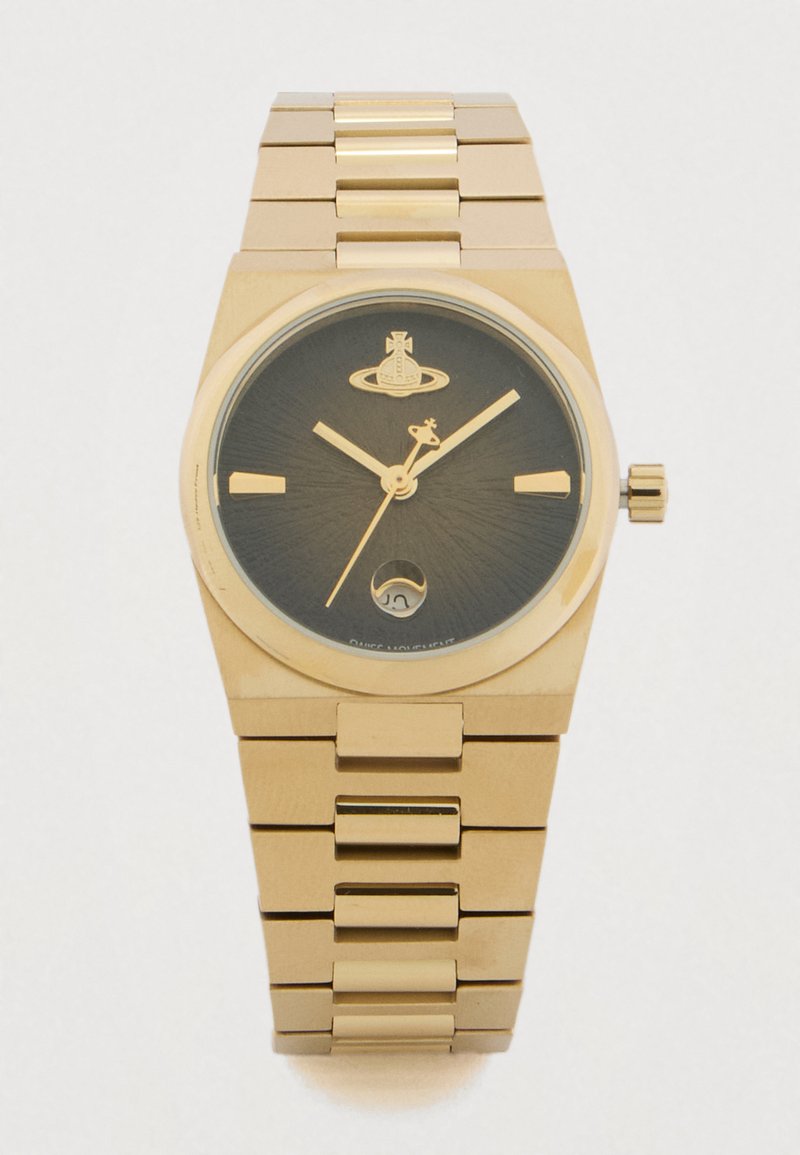 Zelta metāla rokas pulkstenis ar melnu ciparnīcu, zelta stundu rādītājiem, trim rādītājiem, tostarp giraffes formas sekundes rādītāju, un datuma logu pulksten 6 vietā.