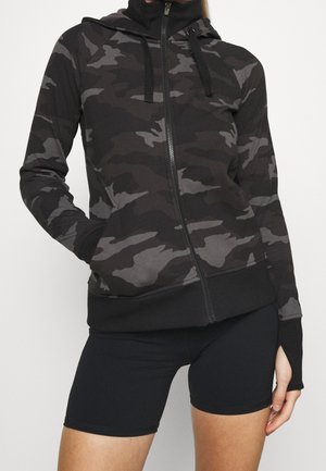 Haut de hoodie zippé noir camouflage avec un haut col, des manches longues et des poignets côtelés. Fait d'un tissu doux et flexible.
