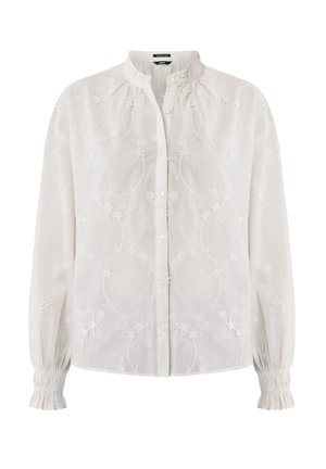 Blusa bianca ricamata con colletto alla cinese, chiusura a bottoni, maniche lunghe e fluide, e polsini arricciati con motivi floreali.