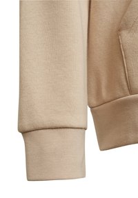 Light beige sweatshirt fabric, featuring a textured knit with ribbed cuffs and a relaxed fit design.