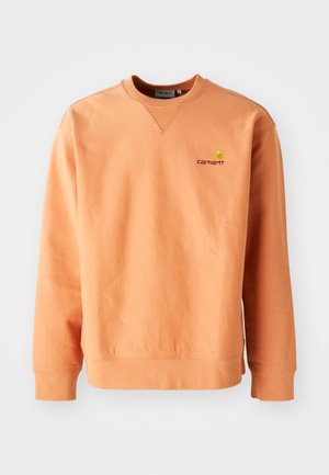 Oranje sweatshirt met lange mouwen en een ronde hals. Ribbelmanchetten en -zoom, met een klein geel Carhartt-logo op de borst. Zachte textuur.