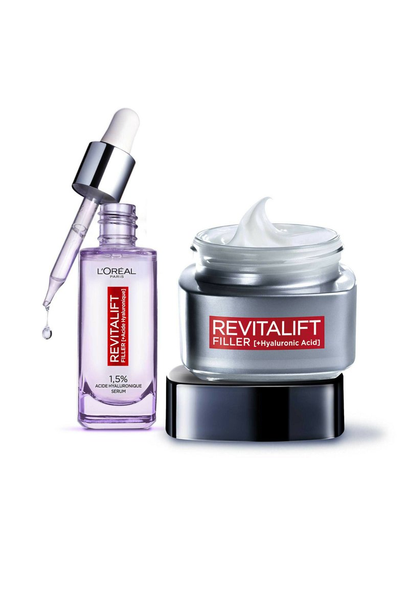 Sérum Revitalift dans un flacon en verre violet haut avec un compte-gouttes et une crème dans un pot argenté avec une base noire et une crème blanche à l'intérieur.