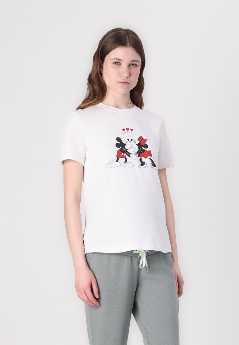 White cotton t-shirt featuring a graphic print of Mickey and Minnie Mouse with red accents and hearts, short sleeves. Paired with gray joggers.