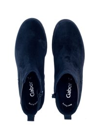 Black suede ankle boots with elastic side panels, round toes, and a textured finish. Features subtle branding on the insole.