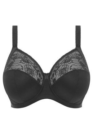 Sostén negro con detalles de encaje en las copas, con tirantes ajustables y una base de tela suave. Incluye un lazo en el centro.