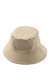 Béžový bavlnený klobúk typu bucket s guľatou korunou a širokou, smerom nadol sa zvažujúcou krempou. Má viditeľné švy a hladkú textúru.