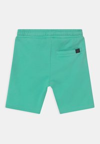 Green, elasticated shorts with a smooth texture, featuring a back pocket and a small brand tag on the right side.