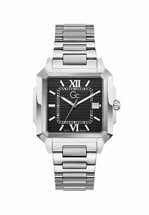 Orologio da polso quadrato in argento con quadrante nero rigato, numeri romani a ore 12 e 6, indicatori argento, finestra della data a ore 3 e cinturino metallico a maglie.