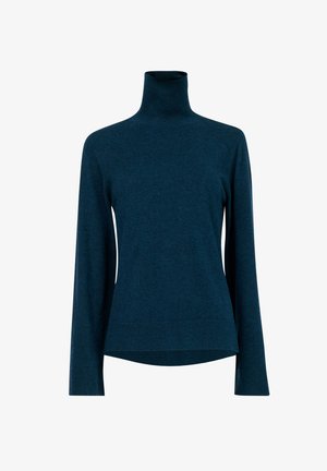 Coltrui in donker teal, gemaakt van zachte gebreide stof. Heeft lange mouwen, geribbelde randen en een relaxte pasvorm met een licht gebogen onderkant.