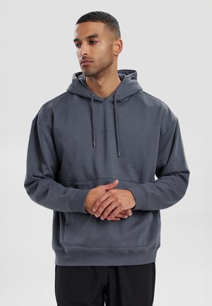 Dark gray pullover hoodie made from soft cotton blend. Features a front kangaroo pocket, adjustable drawstring hood, and ribbed cuffs.