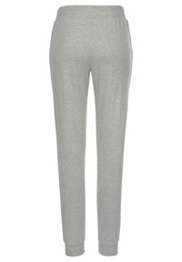 Grey sweatpants made of soft, stretchy fabric; features an elastic waistband, tapered legs, and ribbed cuffs at the ankles.