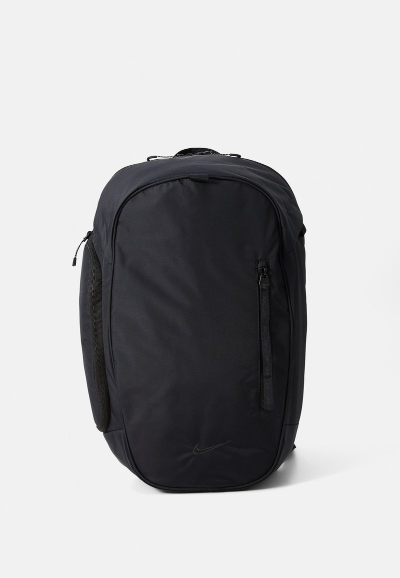 Black Nike backpack with a smooth, matte texture, a zippered side pocket, and a sleek, rounded design. Features a logo on the front.