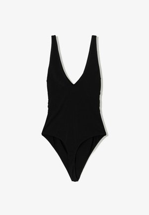 Mustassa haalariasusteessa on syvä V-muotoinen kaula-aukko, hihaton muotoilu ja korkeat lahkeensuut. Silkkinen, joustava kangas minimalistisella estetiikalla.