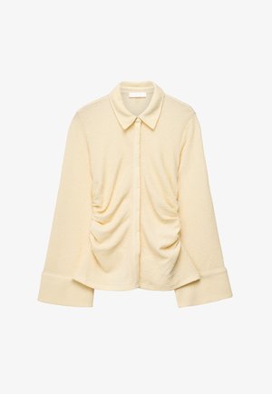 Kreemjas tekstuuriga pika varrukaga pluus laiade mansettide, kogutud külgedega, terava krae ja peidetud ees nööbiliistuga.