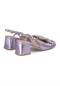 Slingback in metallo viola con tacco quadrato, caratterizzati da un fiocco decorativo e dettagli in strass. Texture liscia, design aperto.