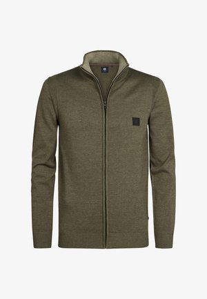 Olivově zelený svetr na zip s žebrovanými detaily, vysokým límcem a malou černou nášivkou na levém prsu. Měkká pletená textura.