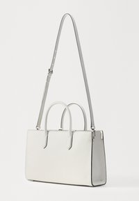 Borsa a mano bianca in pelle con doppio manico e tracolla grigia staccabile. Presenta una forma rettangolare strutturata e dettagli sui bordi discreti.