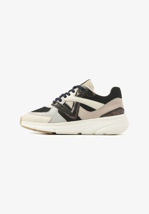 Sneaker featuring a mix of materials: beige leather, black mesh, and metallic accents. Chunky white sole and navy laces complete the design.
