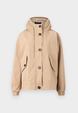 Beež, kapuutsiga jakk lõdva lõikega. Omab nelja esi-taskut, nööpidega sulgemist ja elastseid mansette. Sile kangas mati viimistlusega.