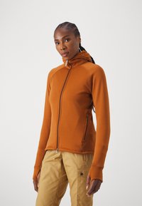 Orange zip-up hoodie med hög krage, med tumhål och dragkedjefickor. Tillverkad av ett glatt, stretchigt tyg.