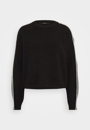 Pull noir en tricot avec un col rond, présentant des rayures blanches le long des manches et un tissu texturé. Longueur cropped et coupe décontractée.