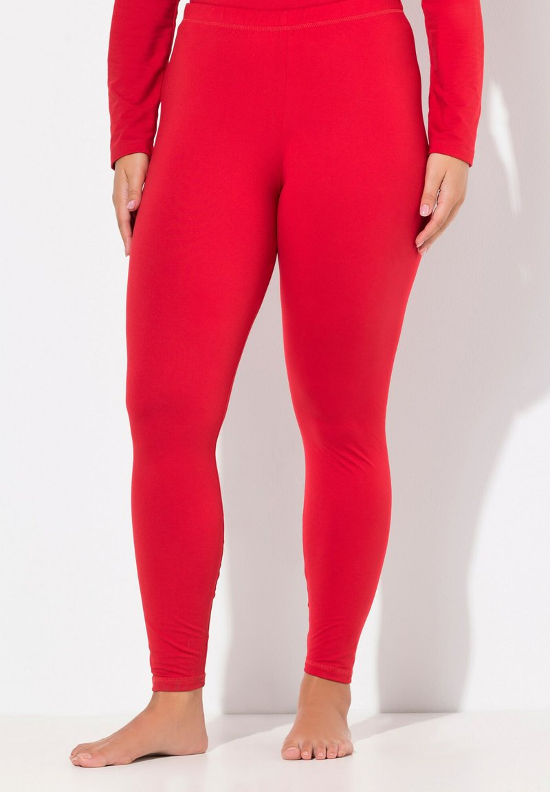 Leggings rossi realizzati in tessuto elastico, con una texture liscia e una vestibilità aderente, dotati di una vita elasticizzata e un design privo di decorazioni.