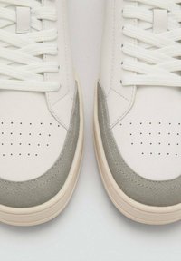 Sneakeri albi din piele cu accente din suede gri, vârf rotund, detalii perforate, şireturi albe plate și o talpă din cauciuc crem.