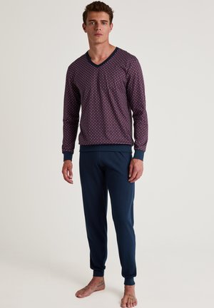 Ensemble de détente bleu marine comprenant un haut à manches longues à motif avec un col en V et un pantalon droit uni avec des chevilles resserrées.