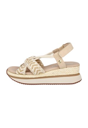 Sandalia cuña beige con tiras tejidas en zigzag, correa en el tobillo con velcro y suela plataforma texturizada con base de agarre marrón.