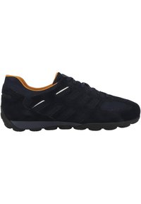 Navy athletic shoe with suede and mesh materials, black rubber sole, orange accents, and a curved design. Features reflective stripes on the side.