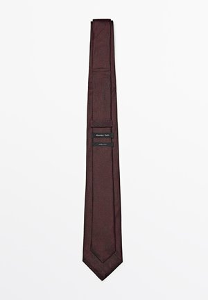 Burgundy tie with a textured finish, narrow design, and pointed tip. Features stitched detailing and a label with "Massimo Dutti" branding.