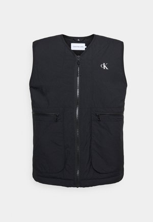Schwarze ärmellose Weste aus leichtem Stoff. Sie verfügt über einen Reißverschluss vorne, zwei mit Reißverschluss versehenen Taschen und ein Calvin Klein-Logo auf der Brust.