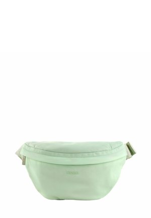 Banane vert menthe en matériau lisse et léger. Elle présente une forme arrondie, une fermeture éclair et une sangle douce avec une boucle réglable.