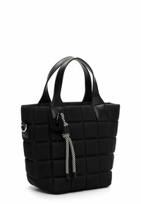 Black tote bag made of quilted leather with a structured silhouette. Features dual handles and a decorative braided tassel with a tag.